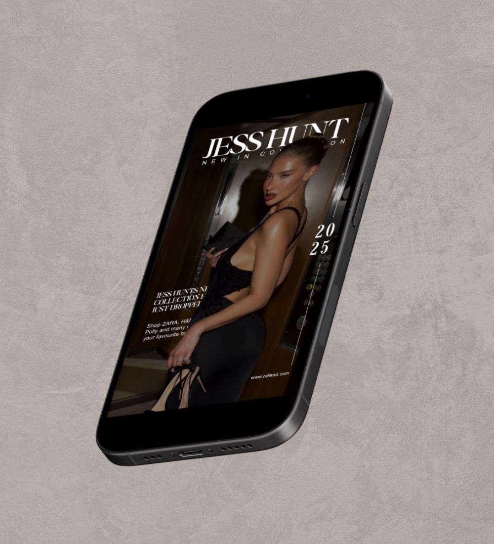 Phone displaying a fashion magazine cover with a model on a gray surface
