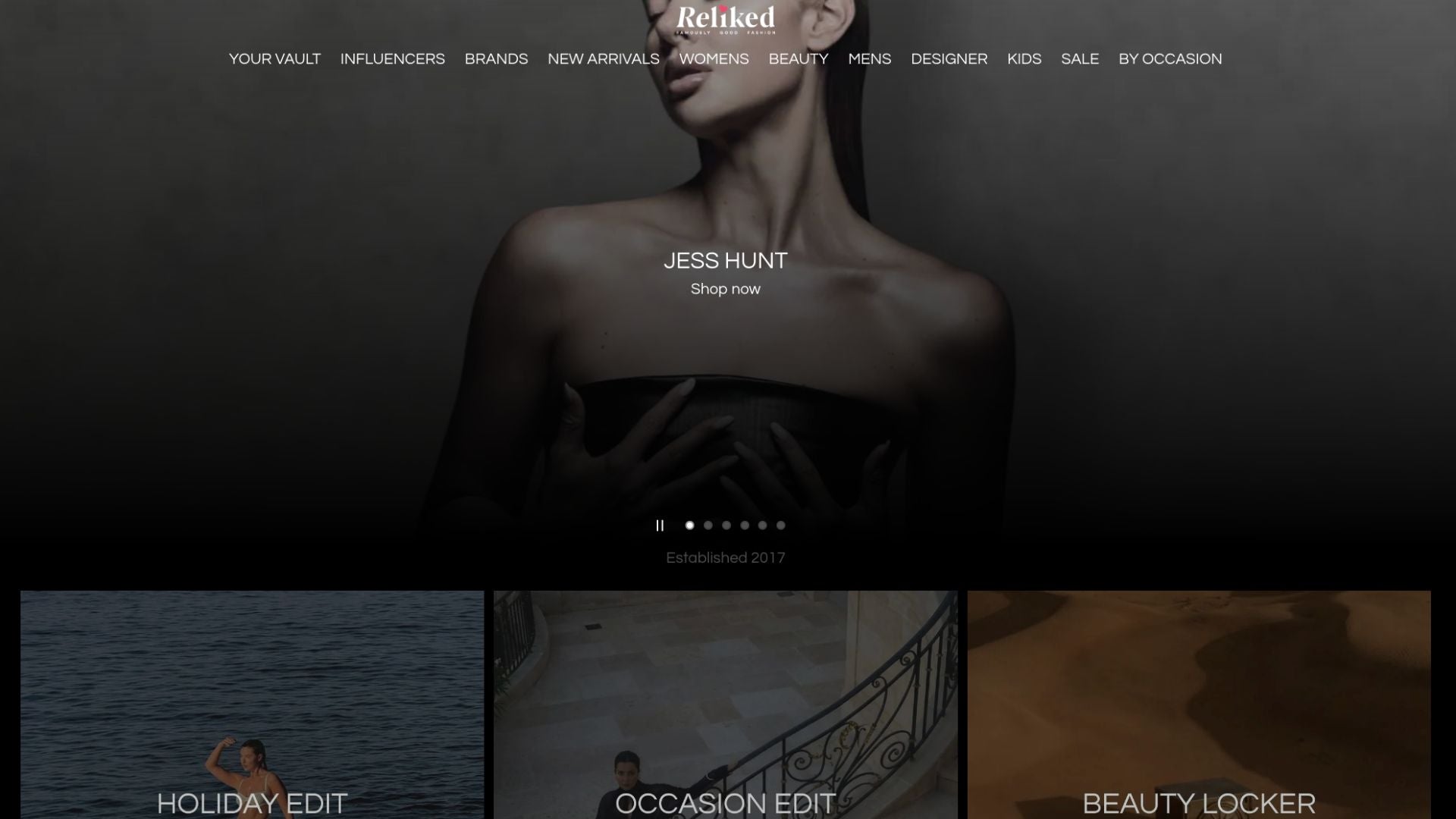 Website homepage with a dark theme featuring a woman in a black dress.