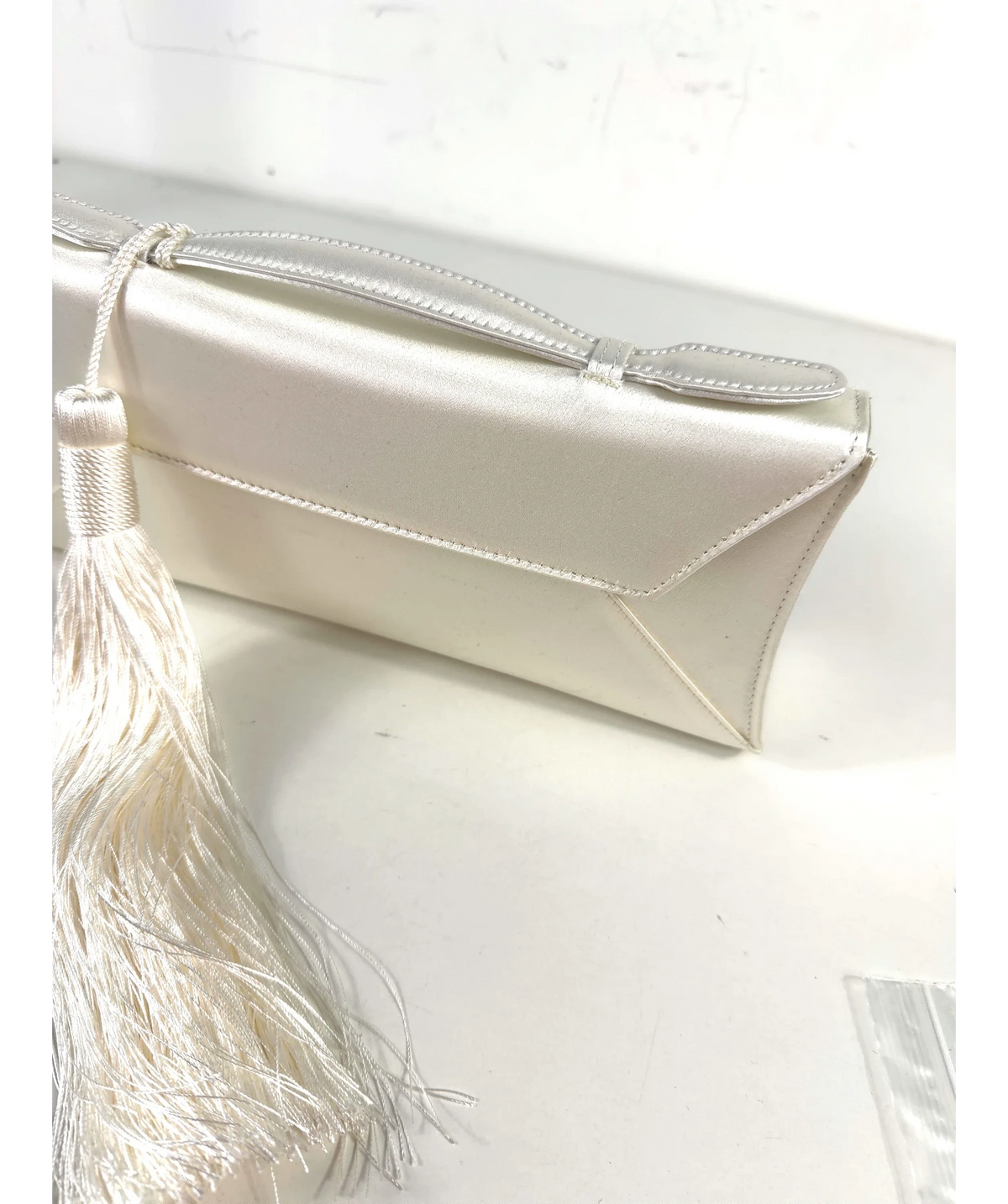AUREUM White Cassandra Clutch Tassel — fabric detail