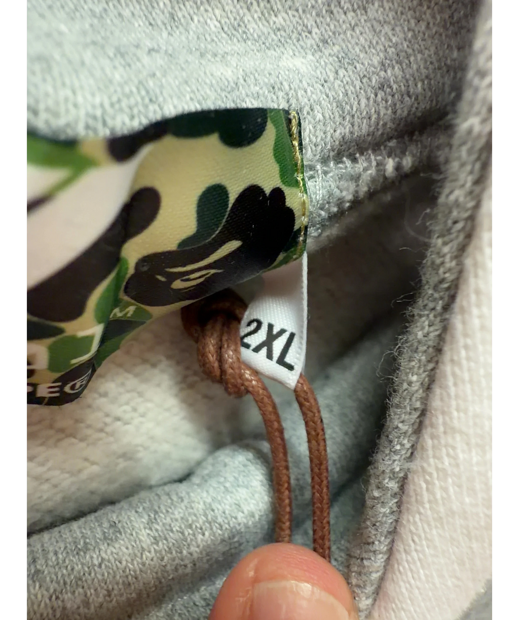 A Bathing Ape Grey BAPE x F1 1000 Two Tone Pullover Hoodie Black/Grey, size UK XXL — care label