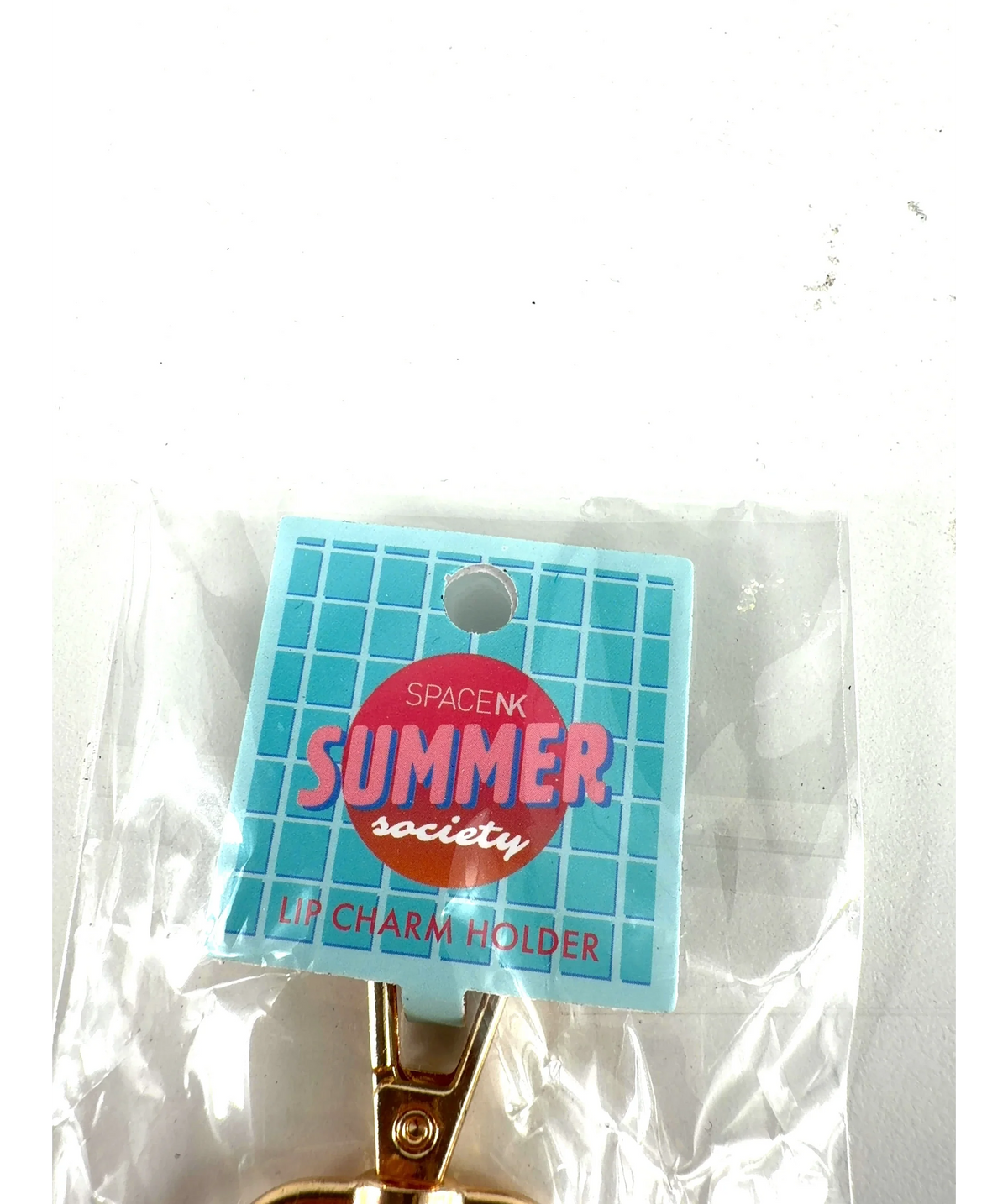 space nk orange LIP CHARM HOLDER, size 1 — label