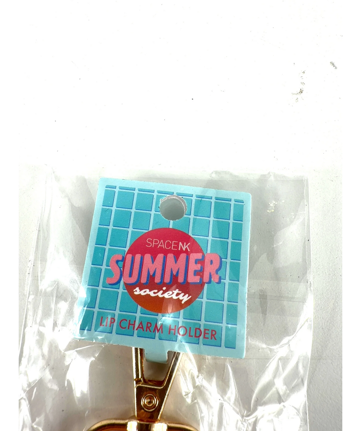 space nk orange LIP CHARM HOLDER, size 1 — care label