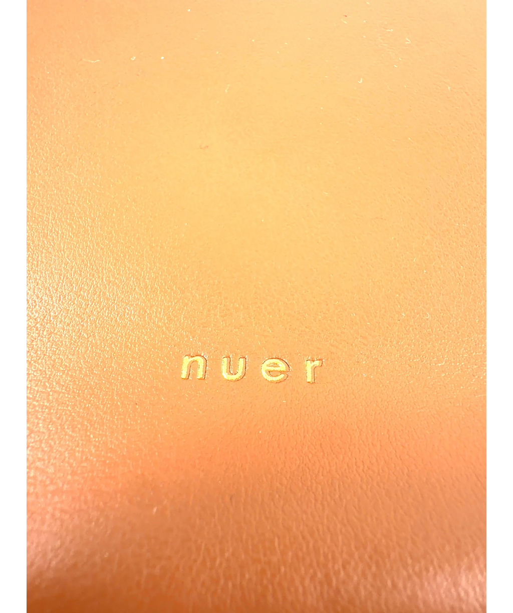 nuer Brown structured trapezoidal frame cross-body bag — label