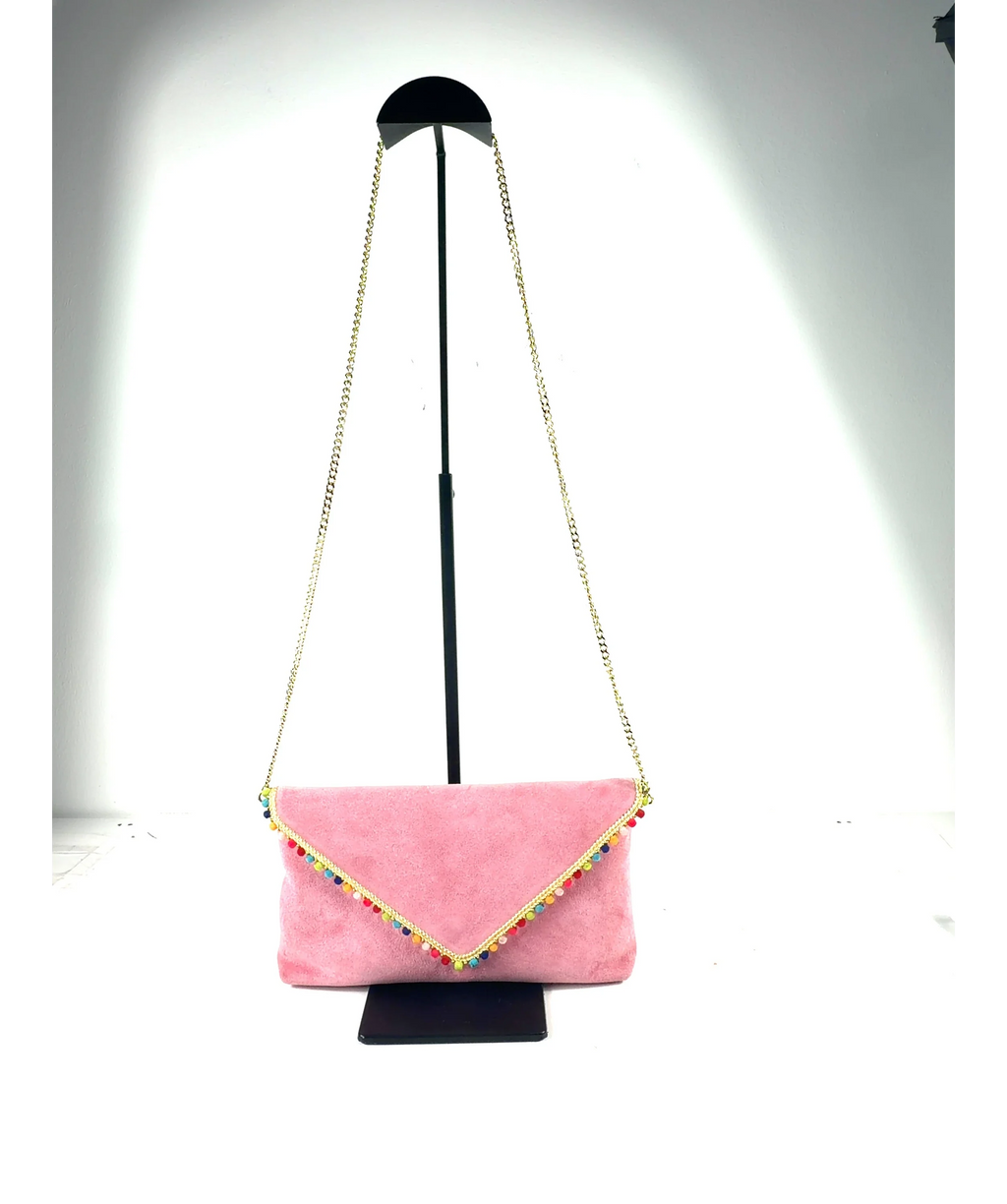 Anthropologie Pink leather/suede envelope clutch with pom-pom trim and a chain strap — care label