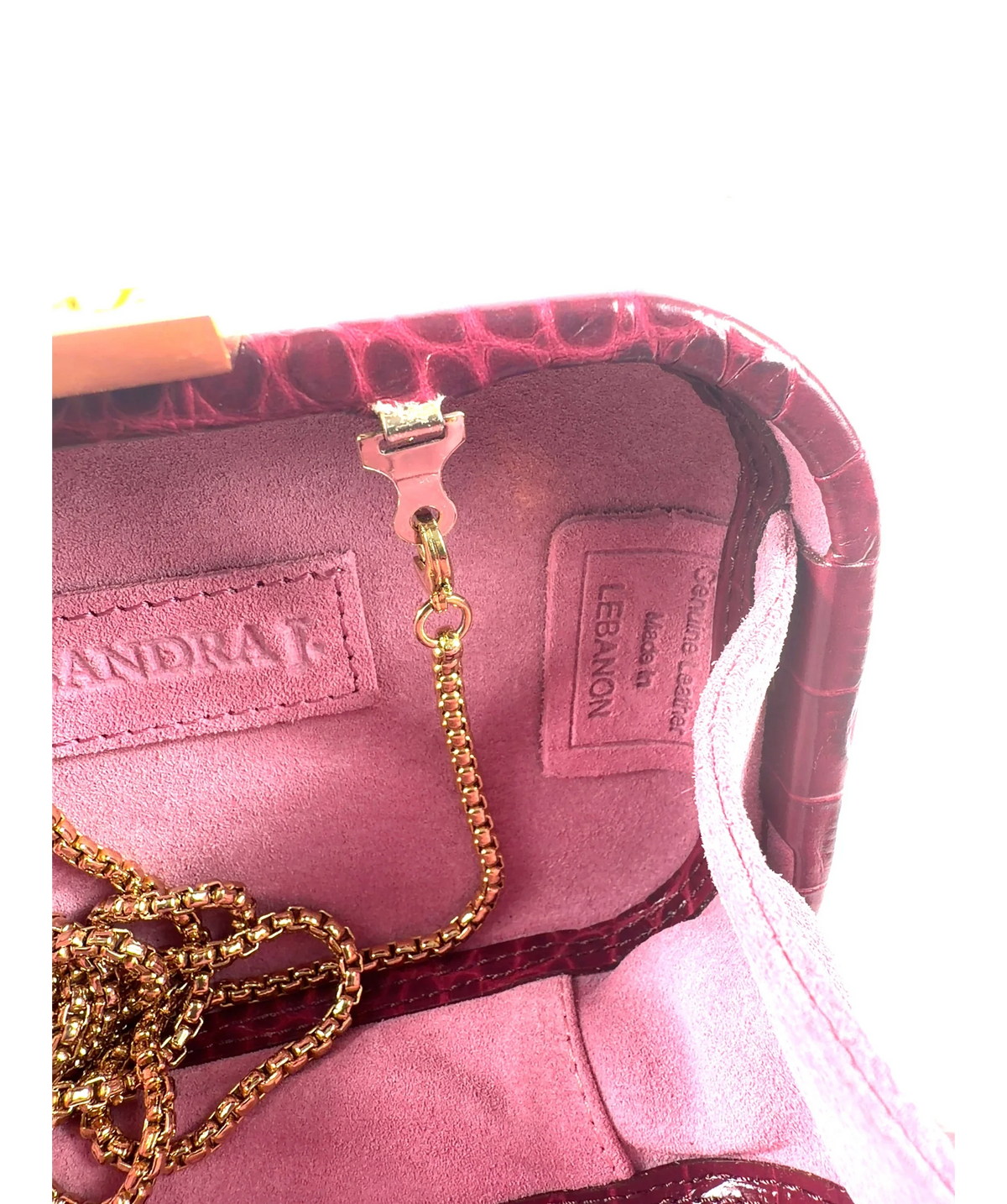 Sandra J. burgundy Sylvana Clutch — label