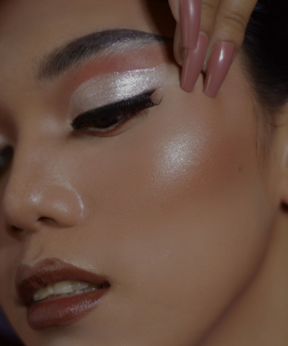 Close-up of a person applying makeup to their eye with a brush.