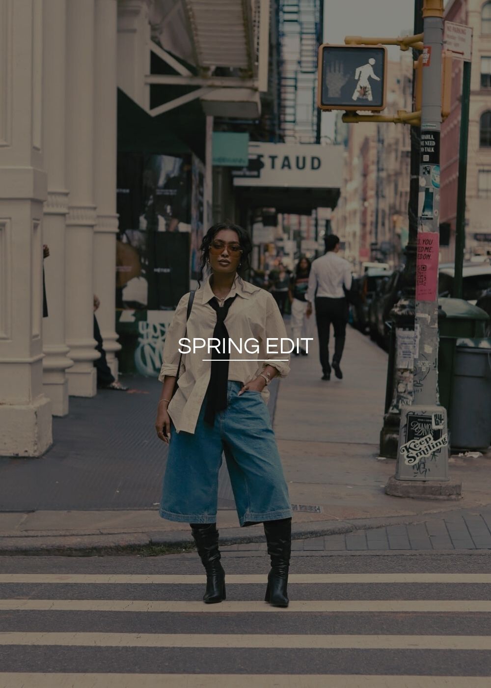 Person walking on a city street with 'Spring Edit' text overlay