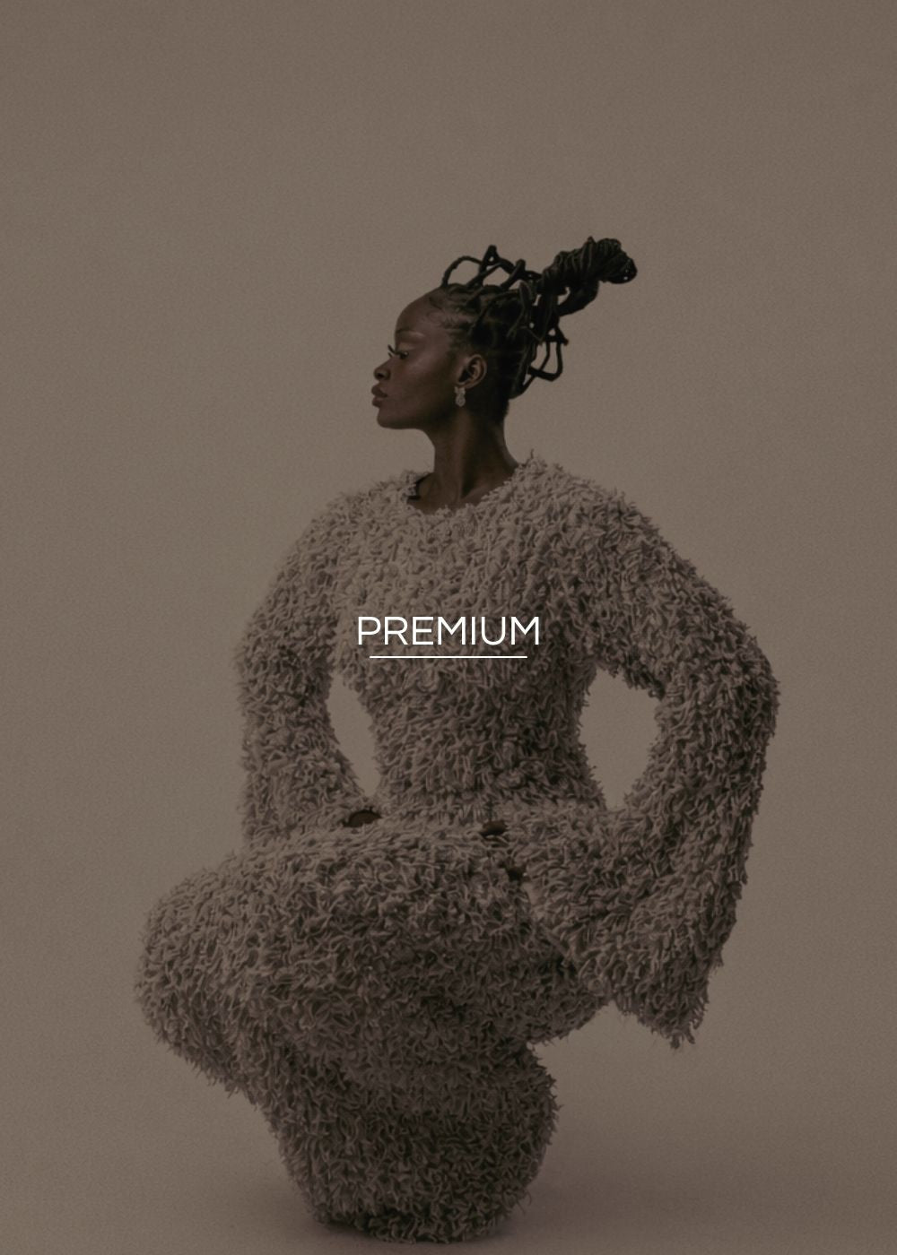 Person wearing a textured outfit with 'PREMIUM' text on a beige background